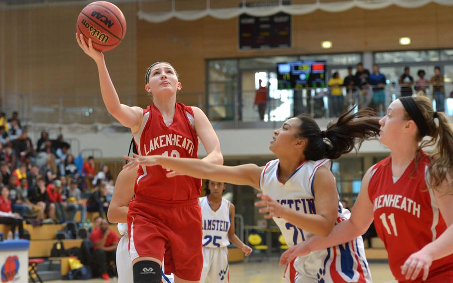 Lakenheath's Amanda Stacy goes to the basket against Ramstein's Ashley Mateo in a Division I semifinal at the DODEA-Europe basketball championships in Wiesbaden, Germany, Friday, Feb. 24, 2017. Ramstein beat Lakenheath 31-28 to advance to Saturday's championship game against Stuttgart. At right is Seraphina Raas.