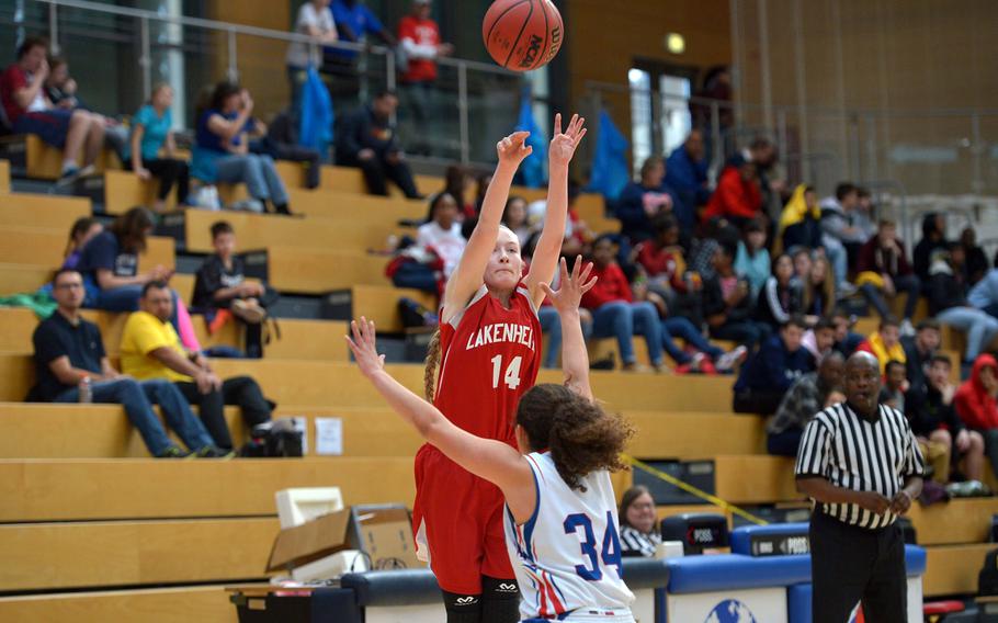 Lakenheath's Reese Estus takes a shot over Ramstein's Haley Deome in a Division I semifinal at the DODEA-Europe basketball championships in Wiesbaden, Germany, Friday, Feb. 24, 2017. Ramstein beat Lakenheath 31-28 to advance to Saturday's championship game against Stuttgart.
