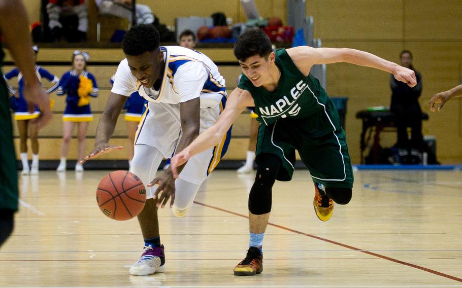 Wiesbaden's Joshua Osakwe and Naples' Omar Lopez race for the ball during the DODEA-Europe Division I semifinals in Wiesbaden, Germany, on Friday, Feb. 24, 2017. Wiesbaden won the game 63-62 in double overtime.