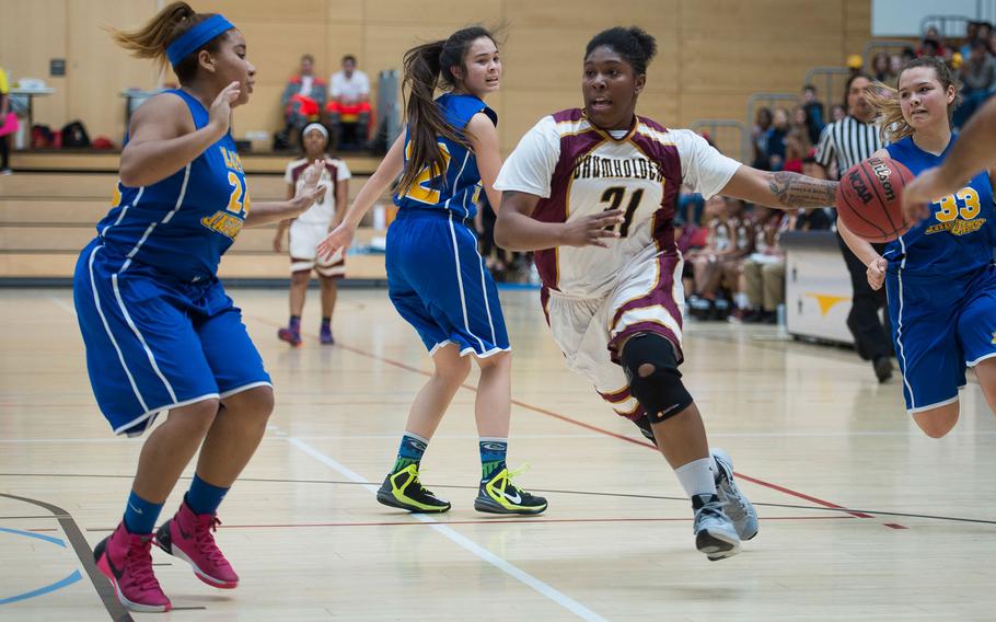Baumholder's Eliya Tillman, right, dribbles towards the basket and Sigonella's Kisiah Chandler during the DODEA-Europe Division III championship in Wiesbaden, Germany, on Saturday, Feb. 25, 2017.