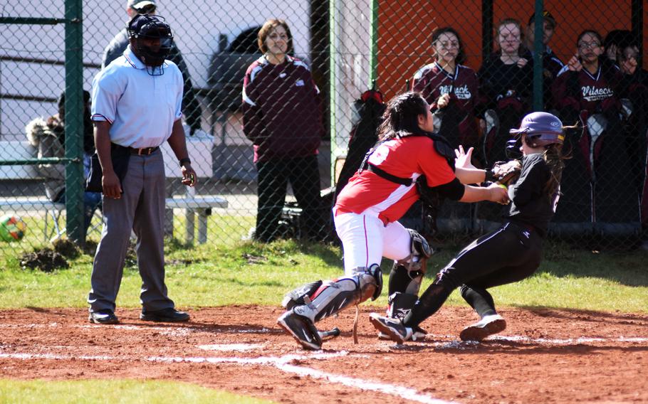 Kaiserslautern's Christine Capalar tags out Vilseck's Natasha Murray before she can score Saturday, but plenty of Falcons did score in a 12-3, 12-1 doubleheader sweep.