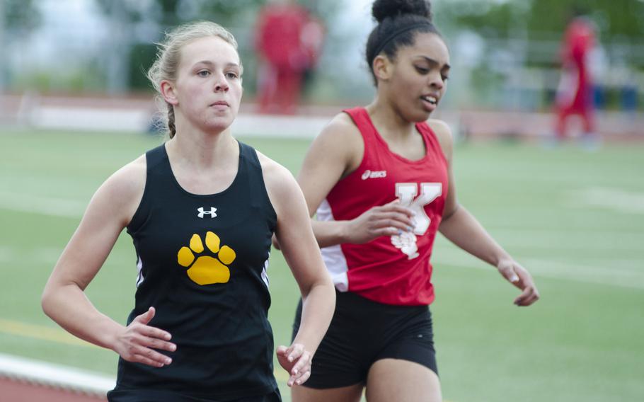 Haley Ramage of Stuttgart, left, passes Ayana Cox of Kaiserslautern in the 400-meter dash at a seven-team meet Saturday, April 15 in Wiesbaden, Germany. Ramage, a freshman, finished first in the heat and 13th overall in the event for the Panthers, who took first place in the girls' division.