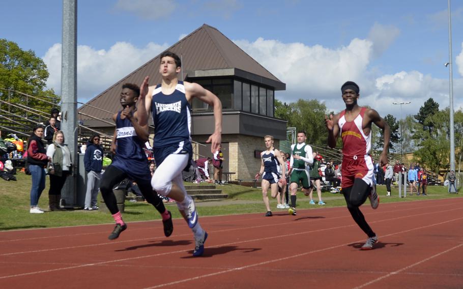 Track athletes sprint to the finish line during the 800-meter run at the opening track and field meet of the season at RAF Lakenheath, England, Saturday, April 15, 2017. 
