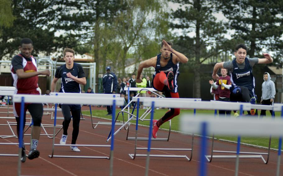 Track athletes race to finish the 100 meter high hurdle event at the opening track and field meet of the season at RAF Lakenheath, England, Saturday, April 15, 2017.