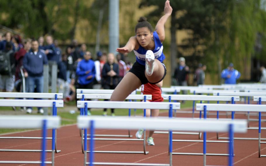 Brussels' Erin Harper runs for first place in the 100 meter  hurdles during the opening track and field meet of the season at RAF Lakenheath, England, Saturday, April 15, 2017. She finished in 17.44 seconds.