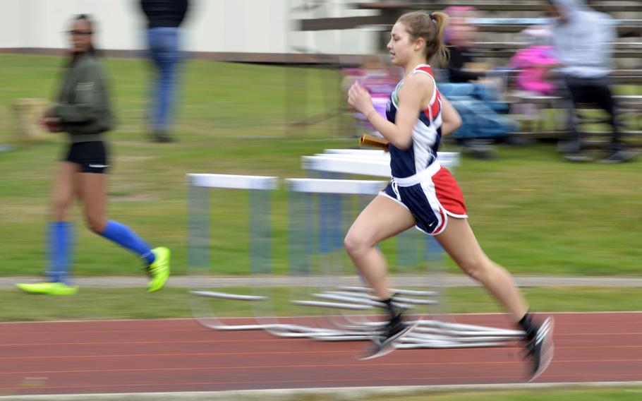 Lakenheath runner Abigaile Smith runs like the wind during the 3,200 meter relay event at the opening track and field meet of the season at RAF Lakenheath, England, Saturday, April 15, 2017. 