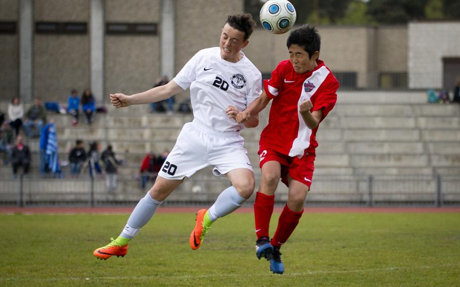 Ramstein's Anthony Villella, left, and International School of Brussels' Koki Otsu jump for the ball at Ramstein Air Base, Germany, on Friday, April 28, 2017. Ramstein won the game 1-0.