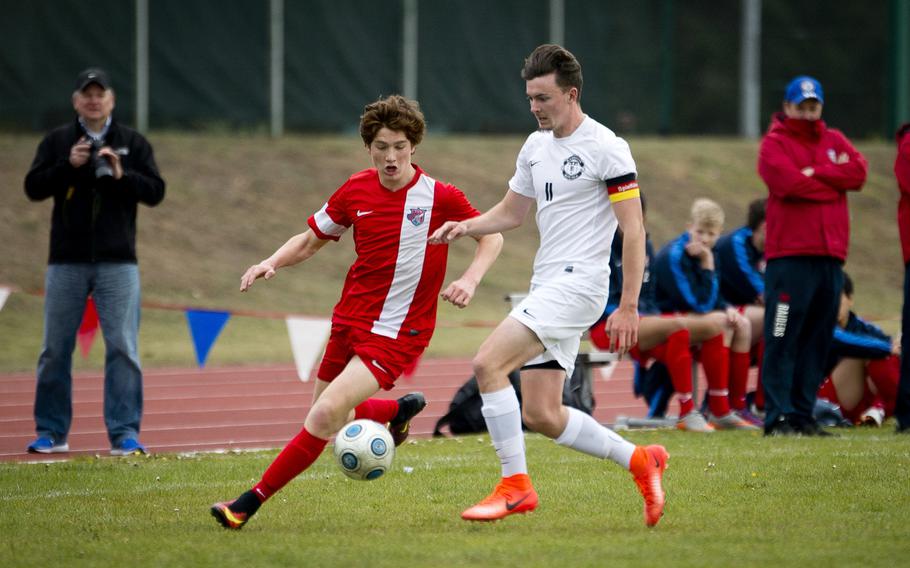 Ramstein's Keal Collins, right, and International School of Brussels' Ben Luca Gericke race for the ball at Ramstein Air Base, Germany, on Saturday, April 28, 2017. Ramstein won the game 1-0.