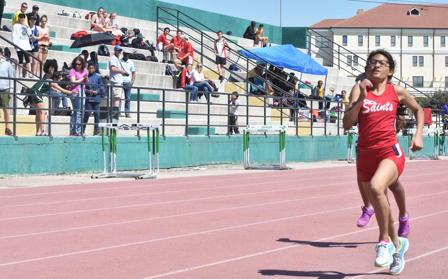 Aviano's Natalia Rodriguez pulls ahead in the final yards of the mile to win on Saturday, April 29, 2017 during a track meet at the Navy Support Site in Gricignano, Italy. 