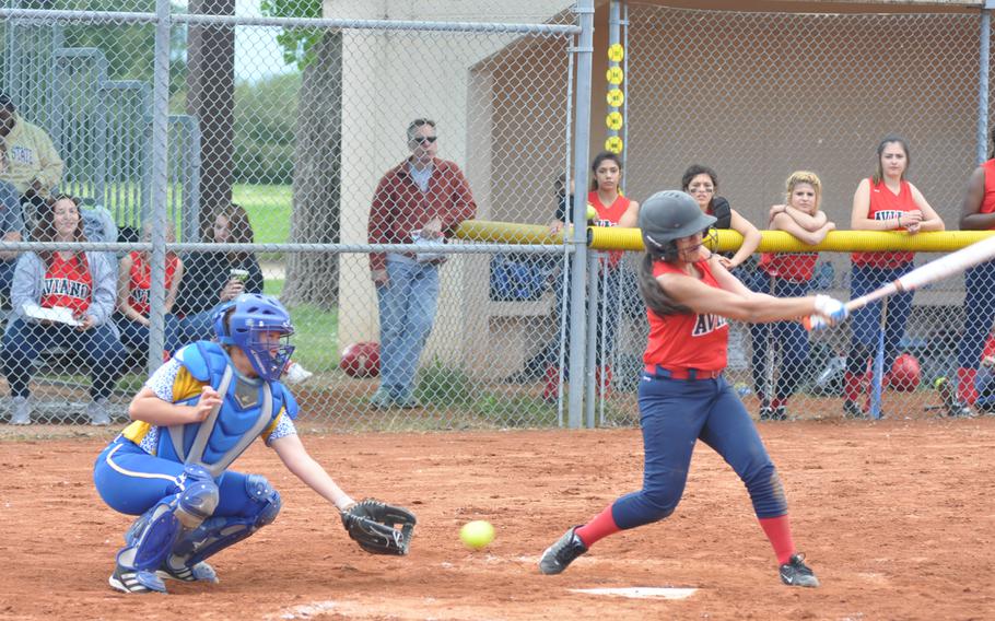 Sigonella catcher Hanna Davis reaches for the ball afer Aviano's Jasmine Vasquez misses it with a swing in the Saints' 12-8 victory Saturday.