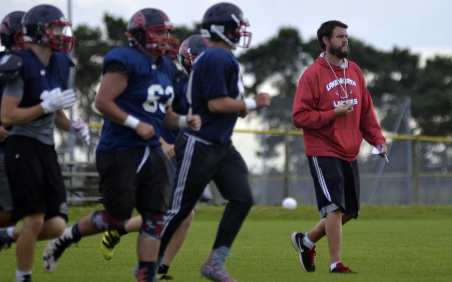 Coach Gabe Feletar with some of his players during football practice at RAF Lakenheath, England, Thursday, August 31, 2017.