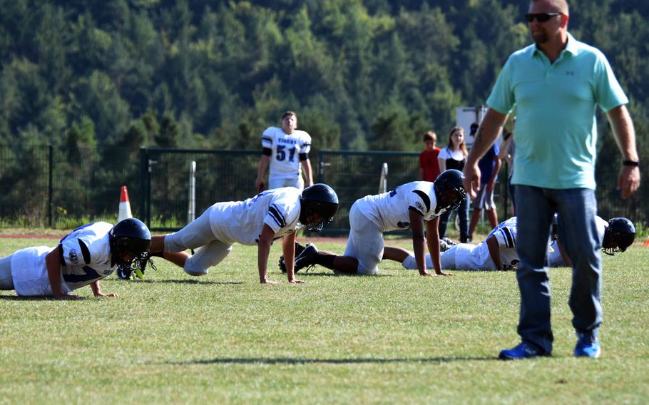 Coach Phil Rigdon watches his team, the Hohenfels Tigers, do pushups during practice at Hohenfels, Germany, Tuesday, Aug. 29, 2017. 