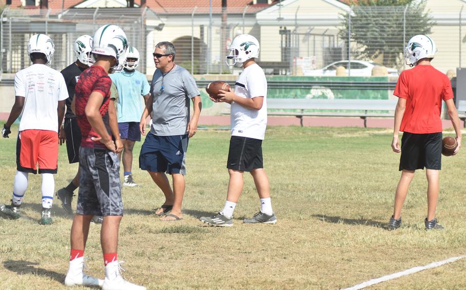 Naples coach Jim Davis  instructs players on an offensive drill during practice on Thursday Aug. 31, 2017 at the high school. The Wildcats' first game of the season will be against the Admirals on Sept. 9 in Rota, Spain. 