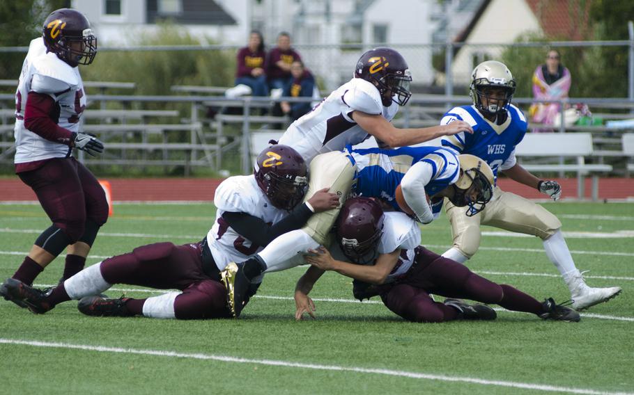 A group of Vilseck defenders take down Wiesbaden running back Chance Arnoldussen in the second half of their early-season matchup on Saturday, Sept. 9, 2017, in Wiesbaden; Germany.
