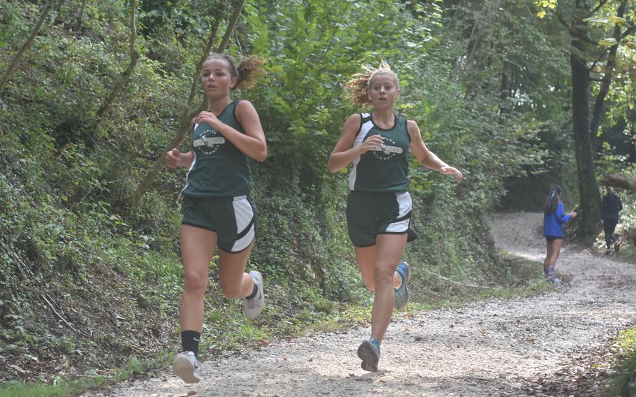 Naples' Clair Elliot, left, and Cate Westbrook came down the hill together Saturday on the 3.1-mile course at Parco di San Floriano. Elliot went on to finish in 22 minutes, 28 seconds - beating her teammate by 8 seconds.