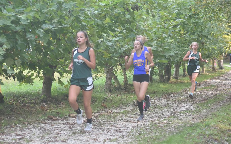 Naples' Clari Elliot leads Sigonella's Alexa Patmor, Sandra Bradley and teammate Cate Westbrook around the first corner of the 3.1-mile course at Parco di San Floriano on Saturday. Elliot won the race and the others finished in the top five.