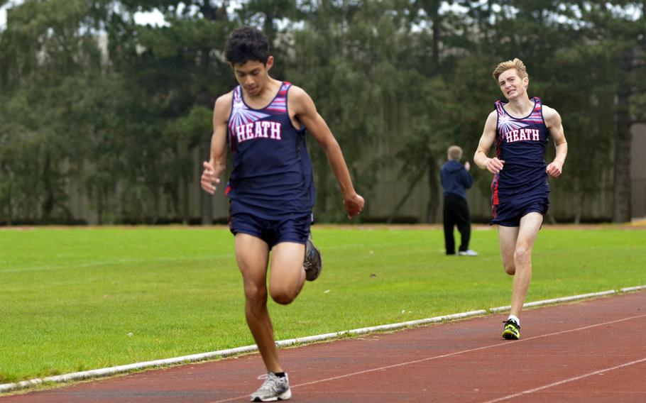 Lancer varsity boys cross country runner Alex Rodriguez  pulls ahead of his teammate Freedom Tansley right before the finish line of a 5-kilometer race against Alconbury at RAF Lakenheath, England, Saturday, September 23, 2017. 
