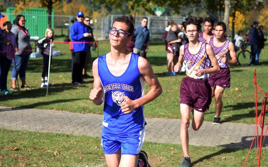 Hohenfels' Elliot Rodriguez runs ahead of a group of Vilseck runners at the cross country race at Vilseck, Germany, Sat., Oct. 14, 2017.