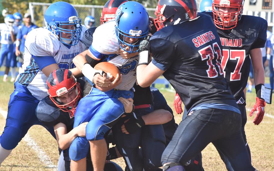 Aviano defenders stop Rota's Brennon Colvin for a short gain in the Saints' 33-30 victory over the Admirals on Saturday.