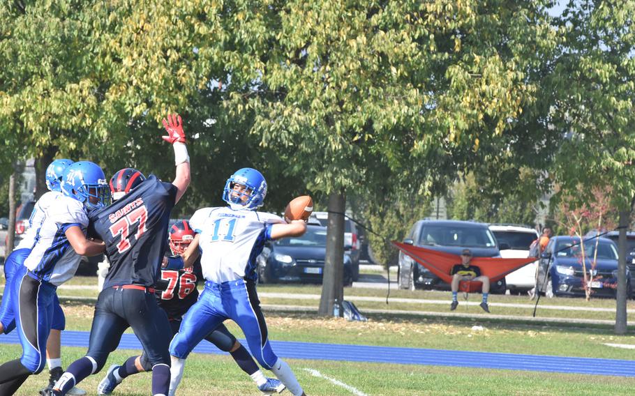Rota quarterback Austin Curtice manages to avoid the raised arm of Aviano's Matthew Robertson on Saturday, but didn't complete the pass and the Admirals fell 33-30.