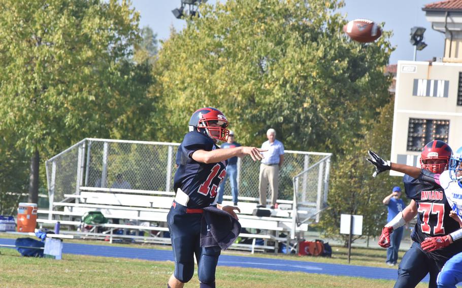 Aviano quarterback Mason Shine lofts the ball towards a receiver in the Saints' 33-30 victory over Rota on Saturday. Shine completed 11 passes for 165 yards.