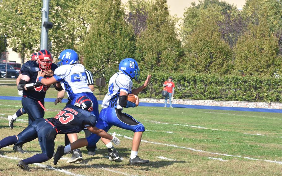 Rota's Brennon Colvin eludes the tackle of Aviano's Pablo Cervantes on the way to scoring his team's first touchdown Saturday in the Saints' 33-30 victory over the Admirals.
