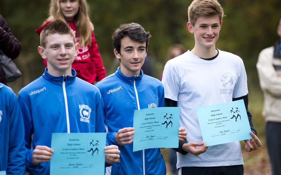 Black Forest Academy's Mac Roberts, right, and Ramstein's Dash Rogers and  Denver Dalpias hold their certificates after a cross country meet in Ramstein-Miesenbach, Germany, on Saturday, Oct. 21, 2017. Roberts won the race with a time of 16:12, Rogers finished second at 16:42 and Dalpias took third place at 17:34.
