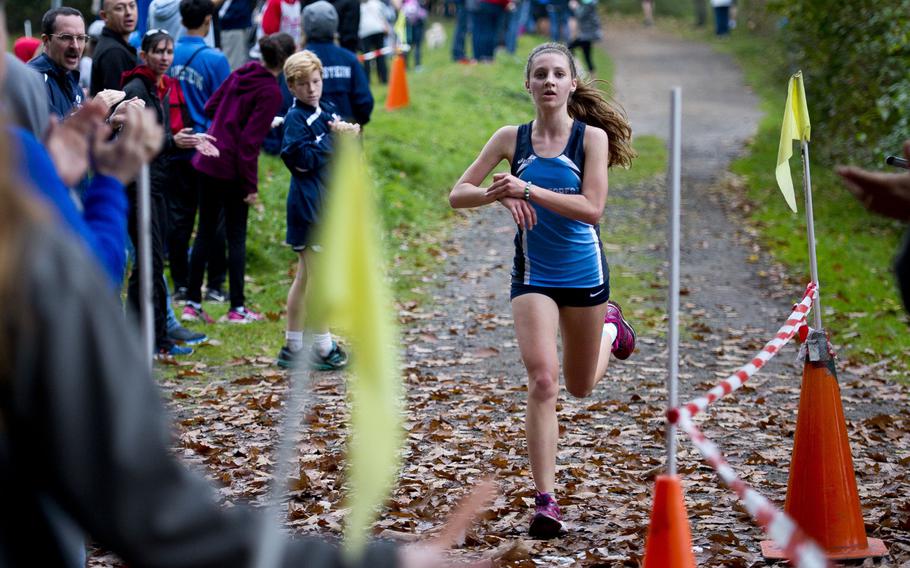 Black Forest Academy's Bianca Liberti crosses the finish line at 20:26 in first place during a cross country meet in Ramstein-Miesenbach, Germany, on Saturday, Oct. 21, 2017. 
