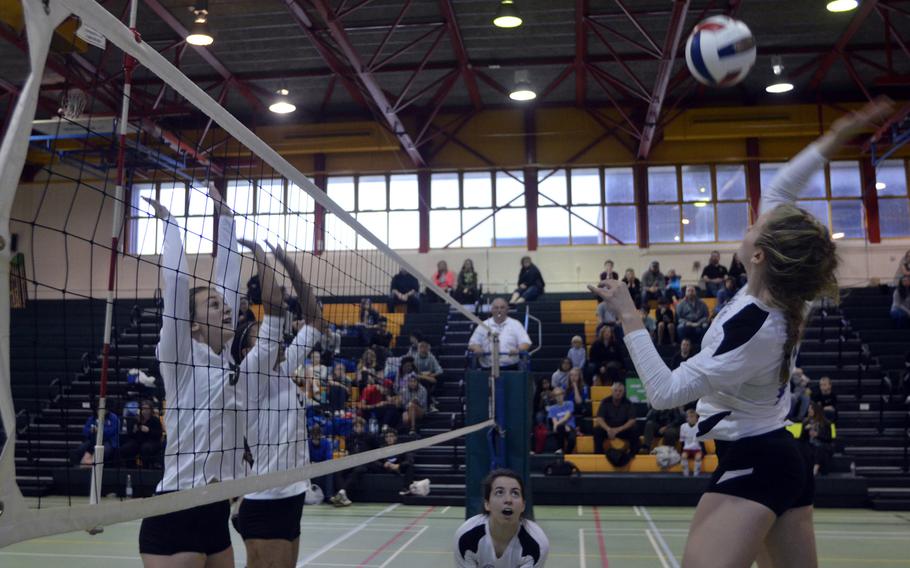 Brussels' Kaylee Sink tries to spike against the Dragons during a varsity volleyball game at RAF Alconbury, England, Saturday, Oct. 21, 2017. The Dragons defeated Brussels 26-24, 18-25, 11-25, 25-20, 15-11. 