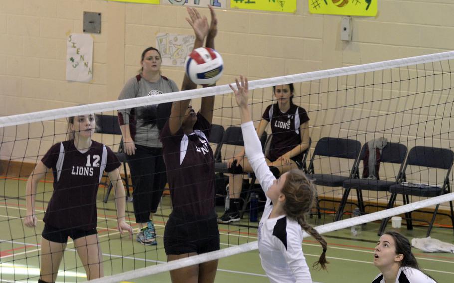 AFNORTH player Milahni Wilkerson blocks against Jewels Friedhoff during a varsity volleyball game versus Brussels at RAF Alconbury, England, Saturday, Oct. 21, 2017. Friedhoff helped her team beat the Lions by contributing six kills and two blocks.  
