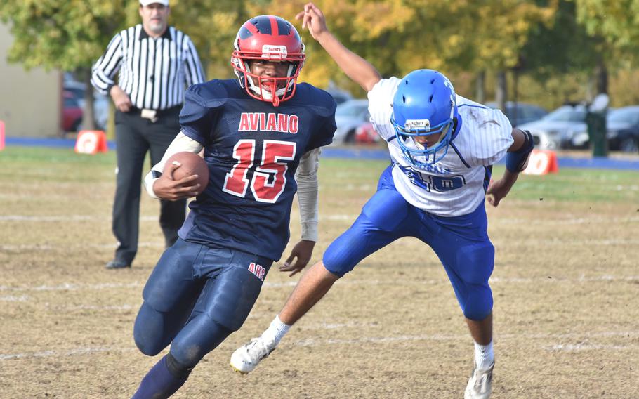 Aviano's Donavin Robinson eludes the tackle of Rota's Joe Perches on Saturday in the second half of Rota's 26-21 victory that sent the Admirals into the Division II championship game.