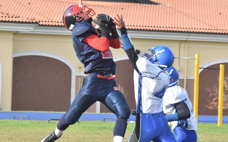 Aviano's Antonio Perales catches a pass from Mason Shine on the 1-yard-line while defended by Rota's Sammy Molina in the Admirals' 26-21 victory Saturday.