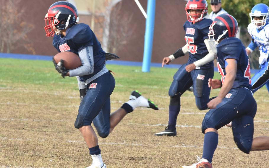 Aviano's Mickey Moore breaks free for a few of his team-high 118 yards in the first half Saturday in the Saints' 26-21 loss to Rota.