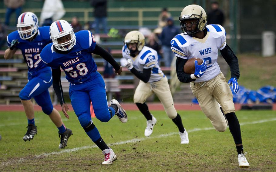 Wiesbaden's Dante Hurt, right, tries to run around Ramstein's Jalon Lewis during the DODEA-Europe Division I semifinal at Ramstein Air Base, Germany, on Saturday, Oct. 28, 2017. Wiesbaden lost the game 13-6.

