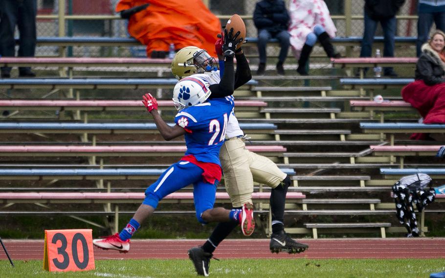 Wiesbaden's Sam Edwards catches a pass over Ramstein's Cameron Chester during the DODEA-Europe Division I semifinals at Ramstein Air Base, Germany, on Saturday, Oct. 28, 2017. Wiesbaden lost the game 13-6.