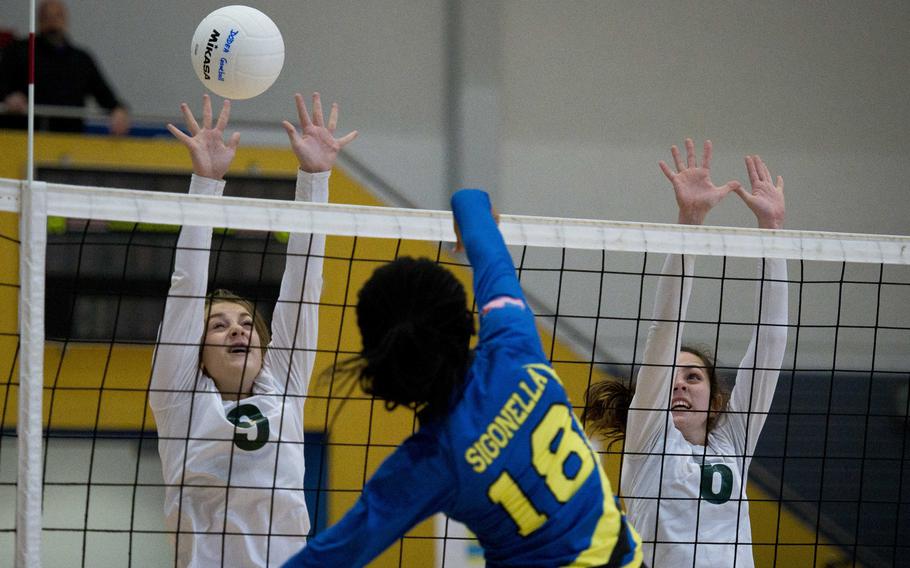 Alconbury's Laela Evans, left, and Natalie Hayosh try to block a shot by Sigonella's Aaliyah Rawlings during a DODEA-Europe championship tournament match at Ramstein Air Base, Germany, on Thursday, Nov. 2, 2017.