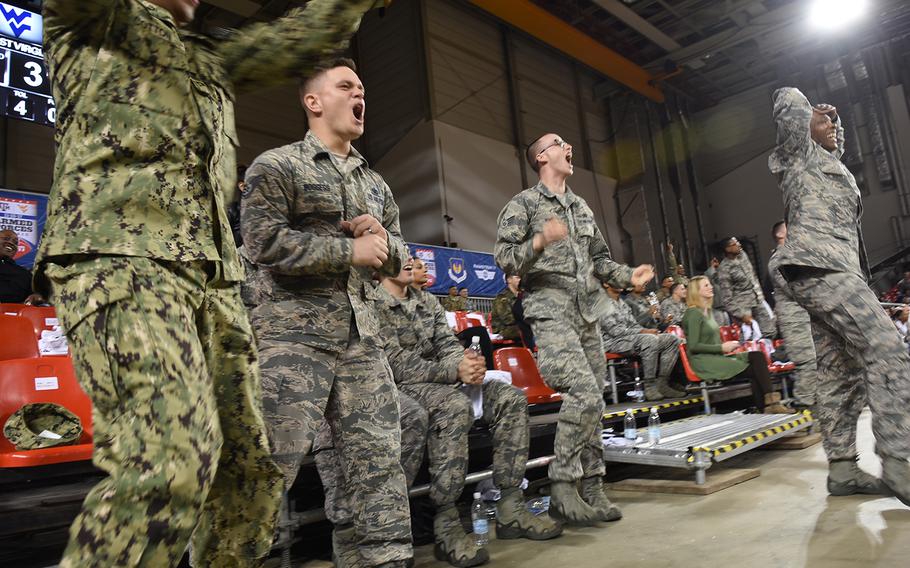 Servicemembers jump, protest and cheer during the Armed Forces Classic on Friday, Nov. 10, 2017, at Ramstein Air Base, Germany.

