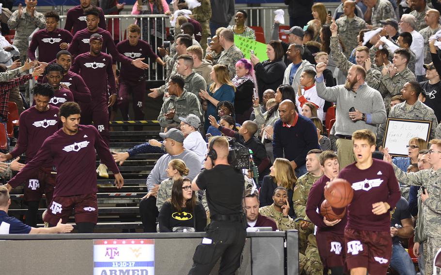 Members of the Kaiserslautern Military Community greet the Texas A&M Aggies as they take to the court Friday, Nov. 10, 2017, at Ramstein Air Base, Germany for the Armed Forces Classic against the West Virginia Mountaineers. 