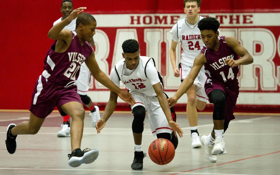 Kaiserslautern's Ervin Johnson tries to dribble past Vilseck's Jemarcus Hughes, left, and Xavier Bynres at Vogelweh, Germany, on Friday, Dec. 1, 2017.