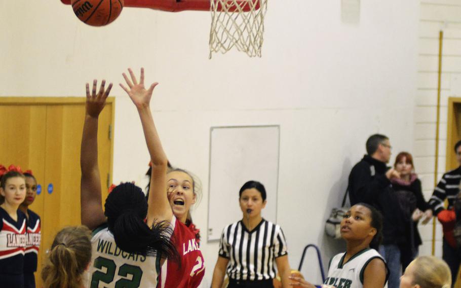 Naples player Mia Rawlins shoots against Lakenheath’s Reiley Kenck during a varsity basketball game at RAF Lakenheath, England, Saturday, December 2, 2017. Rawlins led her team to victory with 14 points.