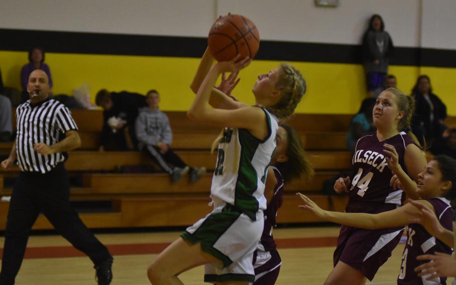 Naples' Roxanne Sasse goes for two points as a host of Vilseck defenders try to chase her down in the Wildcats' 26-15 victory on Friday.