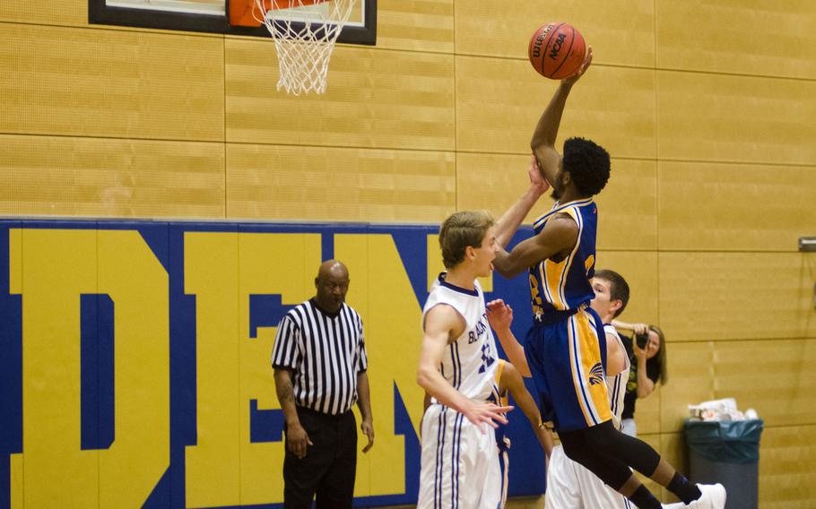 Wiesbaden's Markez Middlebrooks elevates for a short jumper against Black Forest Academy defenders during a DODEA-Europe basketball game Saturday, Dec. 9, 2017 in Wiesbaden, Germany. Wiesbaden's defense set the tone for a strong 55-36 win over perennial Division II power BFA.
