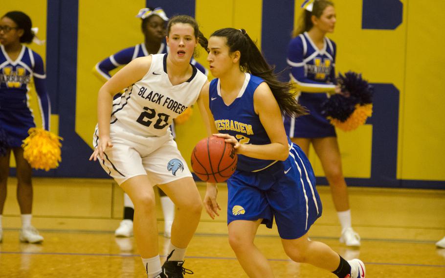 Wiesbaden's Allaina Houk dribbles past Black Forest Academy's Emma Greathouse during a DODEA-Europe basketball game Saturday, Dec. 9, 2017 in Wiesbaden, Germany. BFA defeated Wiesbaden 43-16 in Saturday's game after losing Friday.