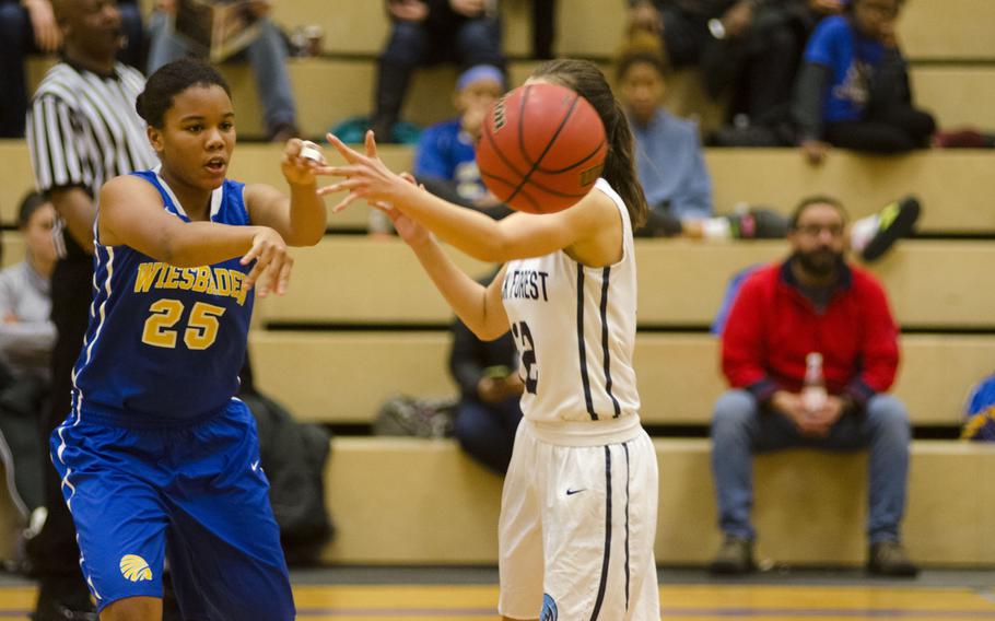 Wiesbaden's Savannah Benson-China passes around Black Forest Academy's Becca Losey during a DODEA-Europe basketball game Saturday, Dec. 9, 2017 in Wiesbaden, Germany. Wiesbaden and BFA split their two-game series on Friday and Saturday.

