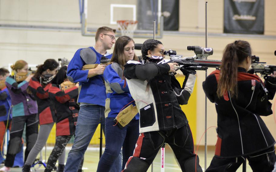 High school students from Wiesbaden, Baumholder, Spangdahlem, Kaiserslautern, SHAPE and Alconbury fire at 10-meter targets in the first western conference marksmanship match at RAF Alconbury, England, Saturday, December 9, 2017. Kaiserslautern won the match with a team score of 1,102.