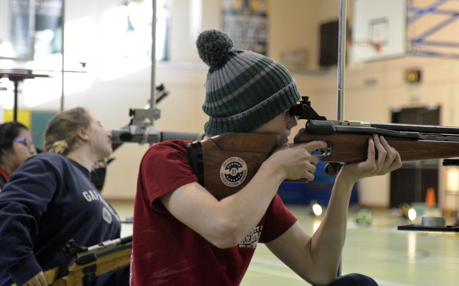 Mitch Gunnerson from SHAPE fires from a kneeling position at a 10-meter target in his team’s first appearance at a marksmanship match at RAF Alconbury, England, Saturday, December 9, 2017. The team from SHAPE just began competing this year