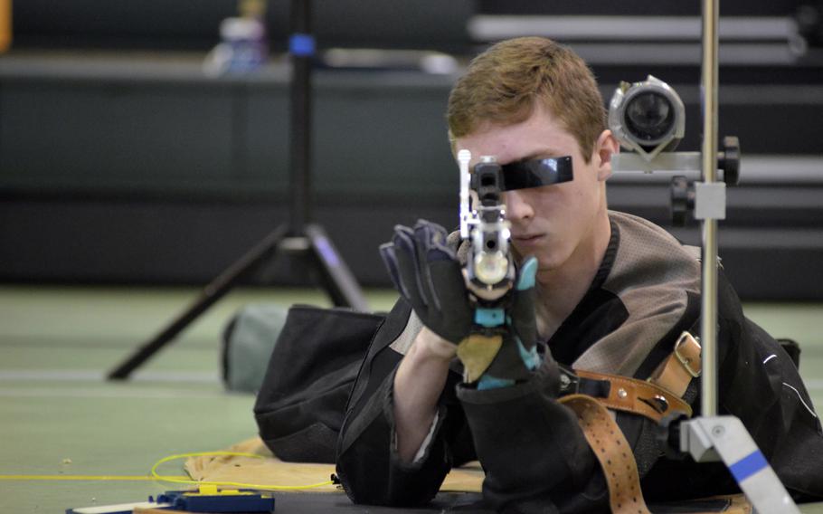 Wiesbaden’s James Wagenblast steadies in the prone to fire 10 shots at 10-meter targets during the first western conference high school marksmanship match at RAF Alconbury, England, Saturday, December 09, 2017. Wagenblast finished in eighth place with a score of 268. 