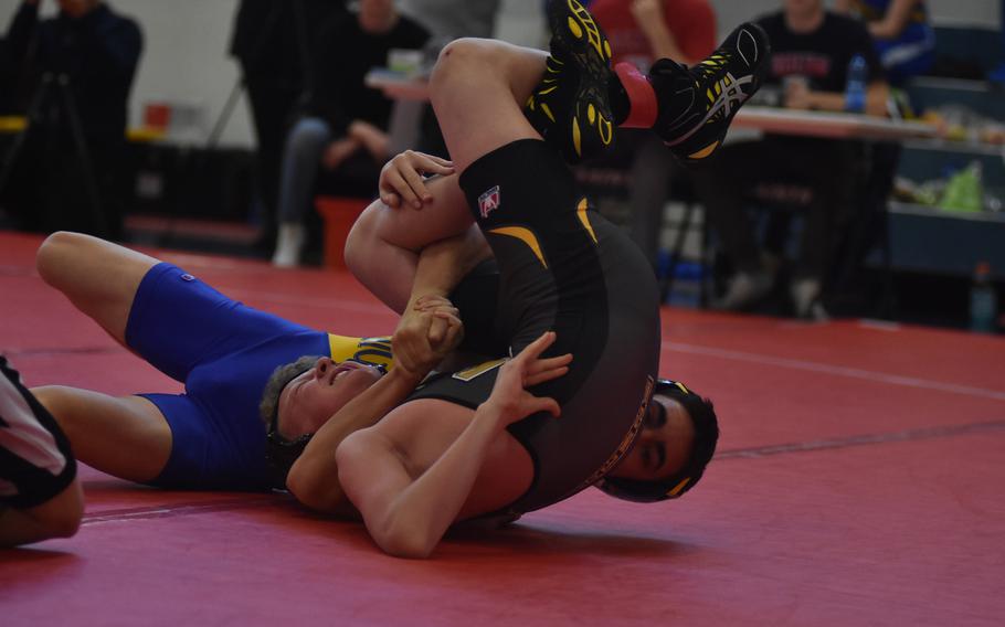 Sigonella's Ben Latimer puts Vicenza's Caleb Smith on his back for a pin at 120 pounds on Saturday at Aviano Air Base, Italy.