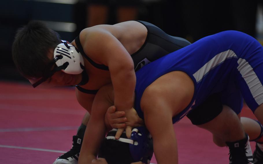 Vicenza's William Paulk pushes the head of Rota's Antonio Corr to the mat in a 106-pound match Saturday at Aviano Air Base, Italy.