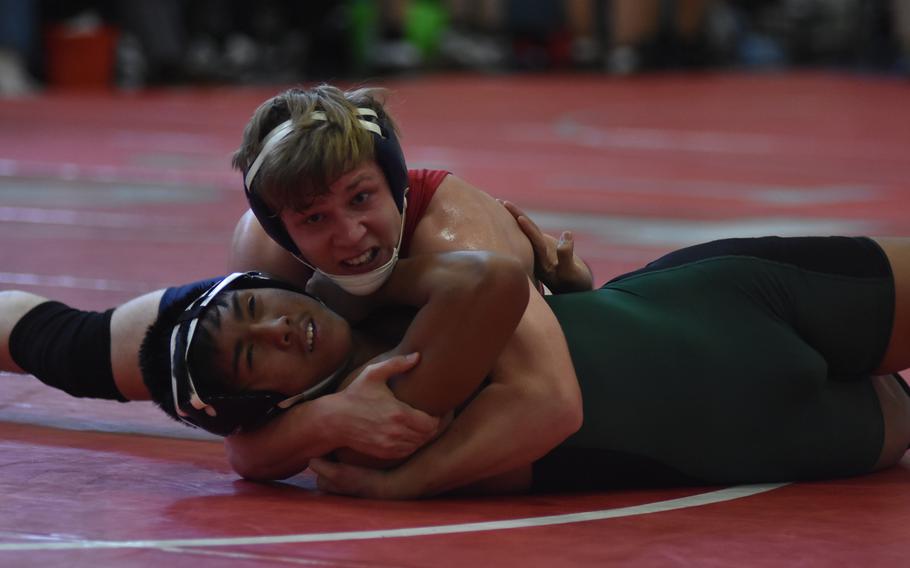 Aviano's Mitchell Schaal gets the best of Naples' Nick Lumanarias in a 170-pound match Saturday at Aviano Air Base, Italy.